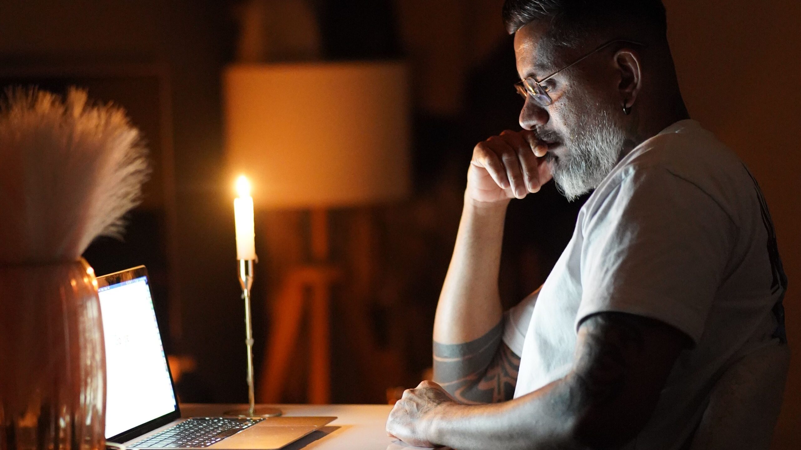 Person continuing to work on a laptop at home in the evening