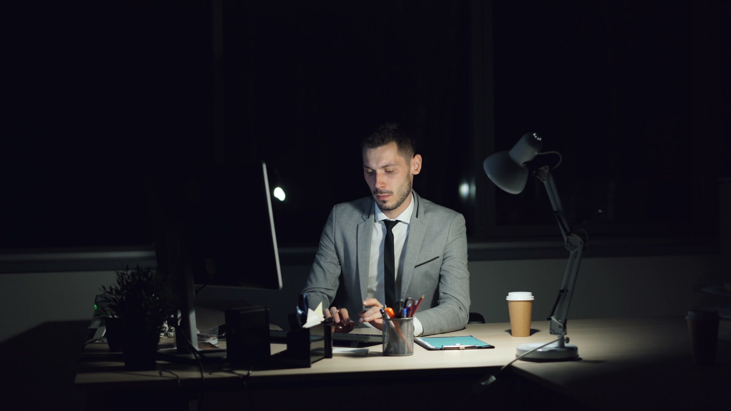 Professional working alone in an office late at night